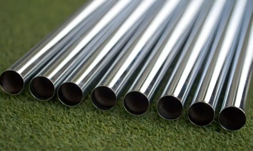 Golf shafts lie on the green.