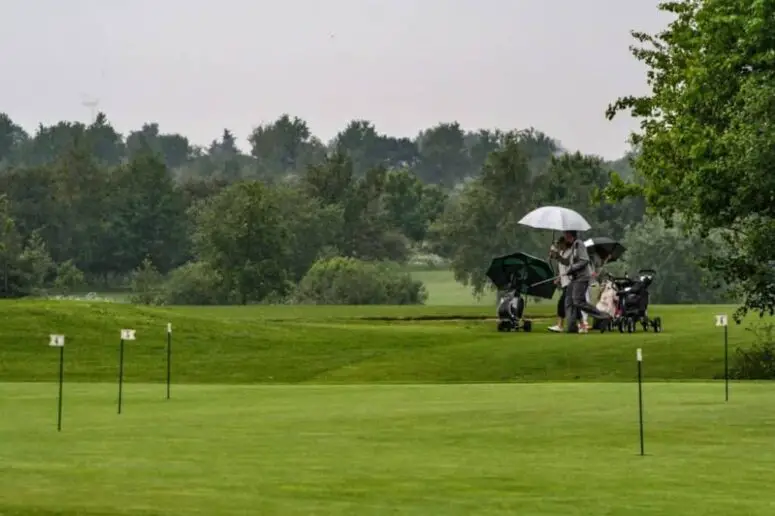 Golfing in the rain.