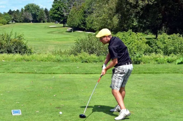 Golfer about to hit the ball.