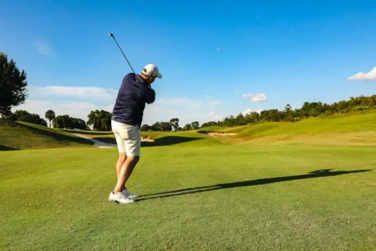 Men playing golf.