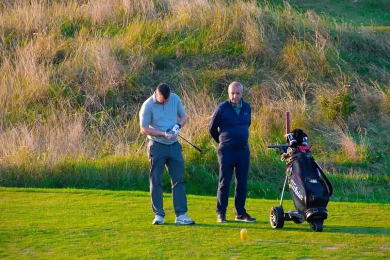 Older men playing golf.