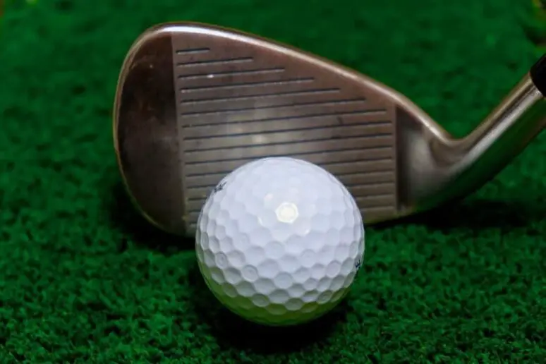 Golf club grooves on a golf club.