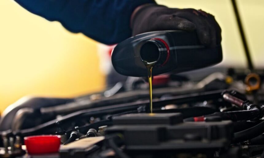 Changing the oil on a golf cart engine.