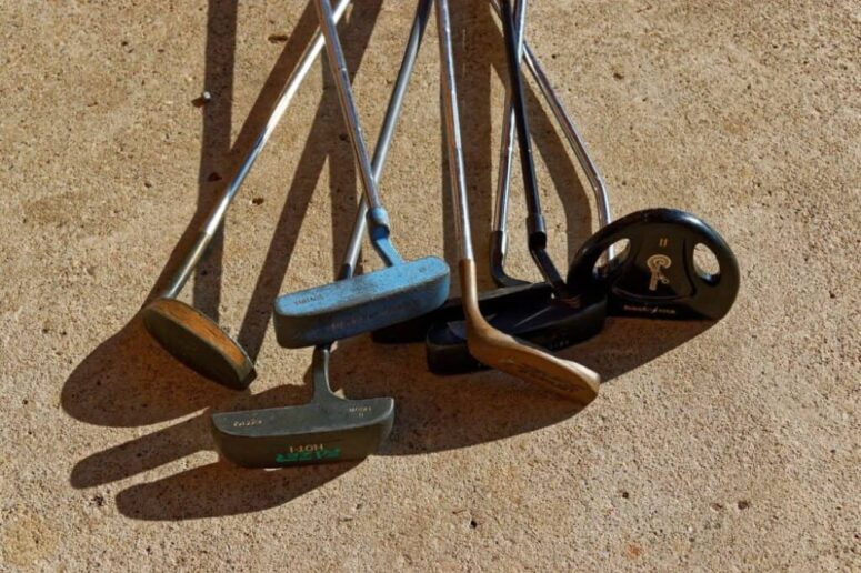 Old Golf clubs including a wood putter.