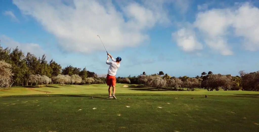 Golfer playing golf on a sunny day.